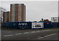 Fenced-off Llys Raddington building site near multi-storey flats, Flint