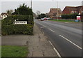 SO8013 : Quedgeley boundary sign in a hedge by Jaggery