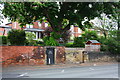 Roadside wall of houses on Potternewton Lane