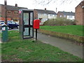 Elizabeth II postbox and telephone box on Woodlands Road