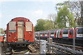 View of a 1992 stock Central line train passing the L11 locomotive