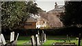 Kiddington Hall and stables from the churchyard