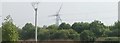 View of a wind turbine and pylon at Beckton from Hand Trough Creek