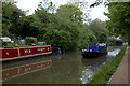 Grand Union Canal. A working boat goes by.