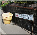 Yellow grit bin and a bilingual name sign on a Tredegar corner