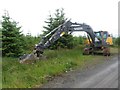 NY6781 : Excavator in Wark Forest by Graham Robson
