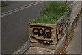 View of a wooden planter with a graffitied face on the Regent