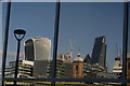 View of a reflection of the Walkie Talkie, Cannon Street station, Gherkin and the Cheese Grater from the South Bank