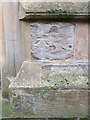 Weathered bench mark on Northop church