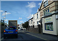 Shop, houses and traffic on Bear Street, looking west