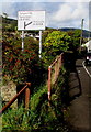 Directions sign in bushes, Trealaw