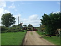 Train passing level crossing near Warham St Mary Railway Halt