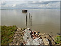 TQ6975 : Remains of the jetty to an old lighthouse on Higham Saltings by Marathon