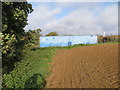 Field side hedge, container and ploughed field at Great Cauldham Farm