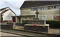 Blackawton War Memorial and a council house behind