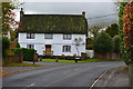 Thatched house beside the road at Urchfont