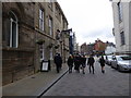 Graduates pass by The Graduate in Sheffield city centre