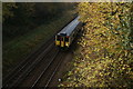 View of a London Overground Class 317 about to pass under the Vestry Road bridge