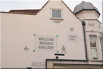TQ3789 : View of direction signs to the William Morris Gallery and Town Hall painted on the side of Salvage Electrical from Ruby Road by Robert Lamb