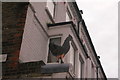 View of a metal chicken above Angara Grill on Walthamstow High Street