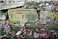 Benchmark on roadside wall of former barn