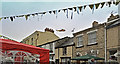 The Chivenor air sea rescue helicopter beyond houses in Pilton Street on Green Man Day