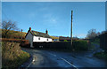 House on a sharp bend in the road near Weddon Cross