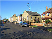 TL4978 : Witchford: Main Street and the Baptist Church by John Sutton