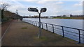 Cycleway signpost next to Infinity Bridge which spans the River Tees