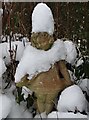 Suburban garden statue in snow