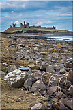 NU2520 : Rocky shore and washed up lobster pot by Peter Moore
