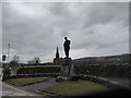 Church spire glimpsed behind the war memorial