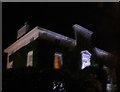 View of an ivy-covered illuminated house on the corner of Maida Avenue and Park Place Villas