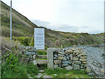 SW8019 : Stone stile and warning sign, coastal path by Robin Webster