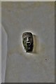 SX3880 : Bradstone: St. Nonna's Church: Odd mask-like carving between two north wall windows by Michael Garlick