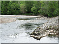 Rock protruding into flow of River Garry