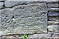 Benchmark on stone in Burnley Road wall