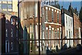 Houses reflected in college windows