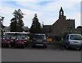 Golf carts, cars and a church bell tower, St Pierre, Monmouthshire