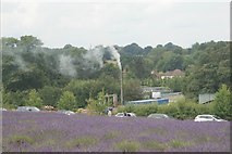 TQ2760 : View of a smoking chimney in Oak Tree Farm from Mayfield Lavender Farm by Robert Lamb