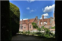 TL8647 : Long Melford, Kentwell Hall: Seen from the huge clipped yew trees by Michael Garlick