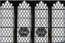TG1127 : Heydon, St. Peter and St. Paul's Church: Two small roundels surrounded by much plain glass in the east window by Michael Garlick