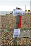 TQ2104 : Warning notices about washed up cargo by Robin Webster