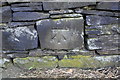 Benchmark on stone in wall on south side of Valley Road