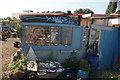 View of an old painted shed in the Nomadic Community Garden