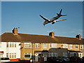 Thai Airways, Boeing 777-3D7, passing rooftops on Waye Avenue