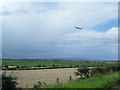 View from A719 near Springbank Cottage with plane taking off beyond