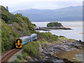 A class 158 train heads along the Dyfi estuary towards Machynclleth