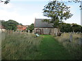 Overgrown  cemetery  off  Holt  Road