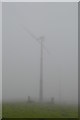 Wind turbine emerging from the mist